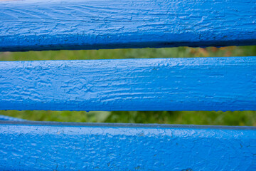 wood painted blue and green in the background