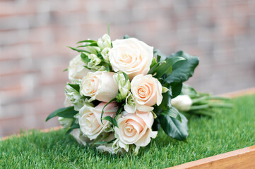 wedding bouquet lying on green grass, white and green flower in a bouquet.