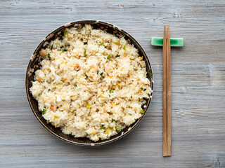 chinese cuisine - top view of yangzhou fried rice in ceramic plate on wooden table