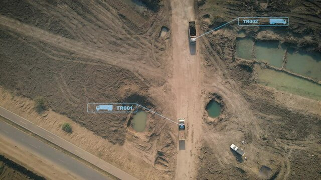 Aerial view of truck and back hoe working in the construction site