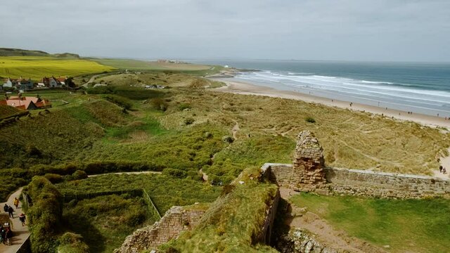 Spectacular view of Bamburgh Castle beach, a pristine, sandy beach, backed by sand dunes in Northumberland, England, UK
