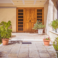 contemporary family house facade and corridor to wooden door, Athens Greece