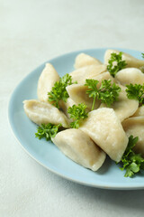 Concept of tasty food with vareniki or pierogi on white textured table