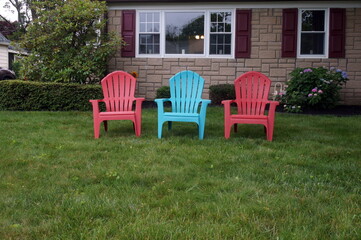 Coral and Aqua Colored Chairs on Front Lawn