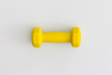 Yellow dumbbell on white background