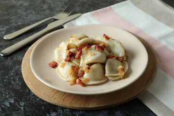 Concept of tasty food with vareniki or pierogi on dark table