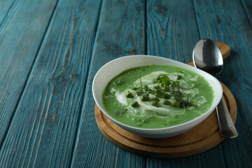 Concept of tasty eating with pea soup on wooden table