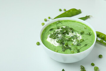 Concept of tasty eating with pea soup on white background
