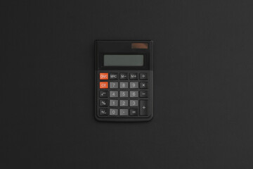 Calculator on black leather background. Back to school