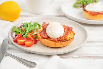 Poached egg and bacon on toast. breakfast.