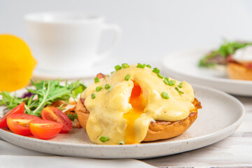 Eggs Benedict on toasted muffins with bacon. hollandaise sauce