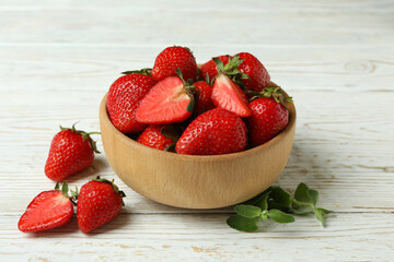 Bowl of strawberry on white wooden background