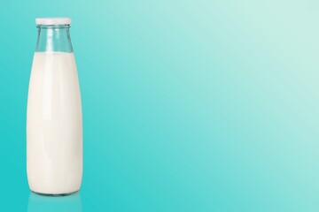 Glass bottle of white milk on the desk