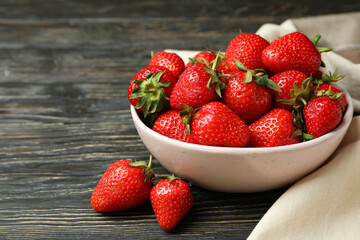 Concept of tasty eating with fresh strawberry on wooden table