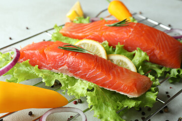 Concept of cooking salmon on white textured background
