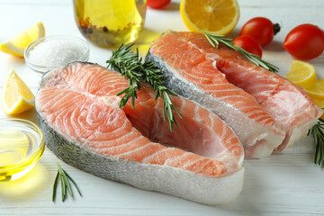 Concept of cooking salmon on white wooden table