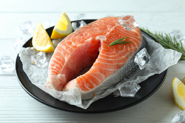 Fresh raw salmon on white wooden table