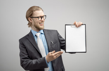 happy businessman holds in hand empty white sheet