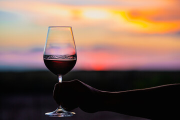 Sunset with a glass of wine.Beautiful sky with sunset with a glass of wine.A glass of wine at...