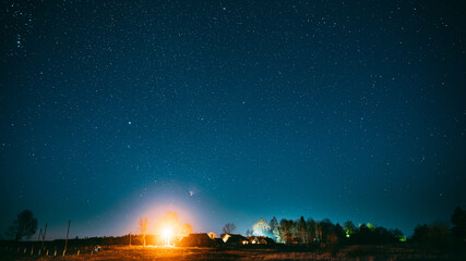 Real Night Sky Stars Above Old Village. Natural Starry Sky Above Rural Landscape In Belarus