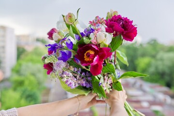 Close-up of bright bouquet of flowers in female hand