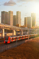 Obraz premium Passenger transportation on the background of modern buildings and road overpasses