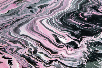 Black and pink waves of paint. Abstract background with marble effect