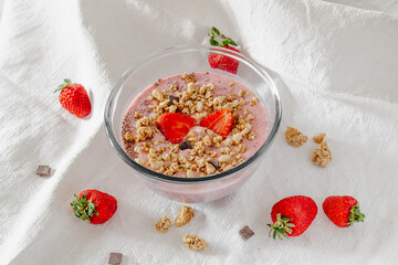 Chia strawberry pudding and coconut milk in a glass bowl. Healthy breakfast. Vegan recipe