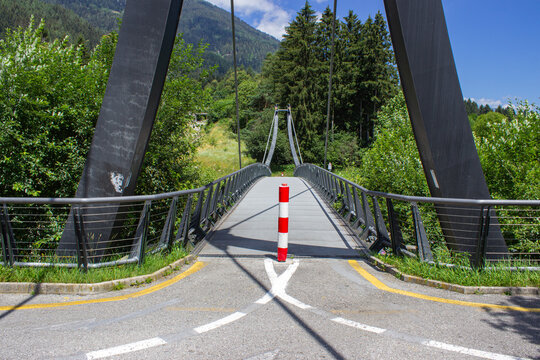 The Val Rendena cycle path. Bridge of the cycle path that crosses the Sarca river. Sunny summer day. Pinzolo, Italy.