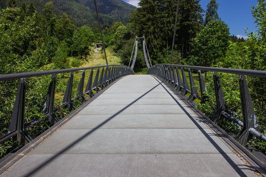 The Val Rendena cycle path. Bridge of the cycle path that crosses the Sarca river. Sunny summer day. Pinzolo, Italy.