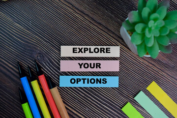 Explore Your Options write on sticky notes isolated on Wooden Table.