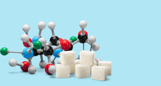 Diabetes awareness and chemical structure concept with a plastic model molecule and sugar cubes.