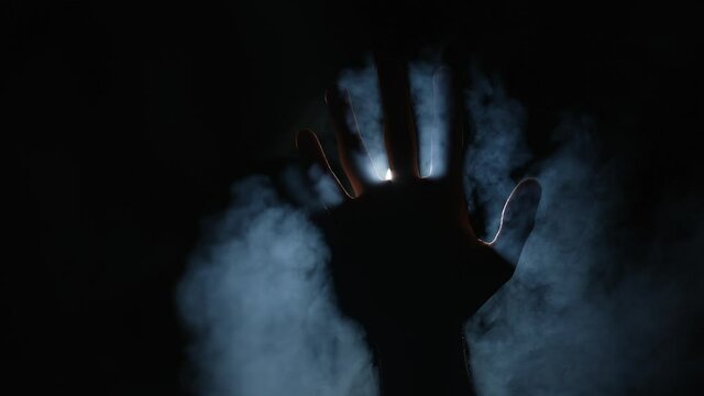 Paranormal activity. Hand in smoke.