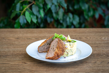 fried minced meat cuttings with potato salad