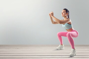 Fototapeta premium Fitness smiling woman in sports clothing do exercises
