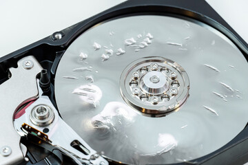 Destroyed, broken, crushed hard disk drive close up