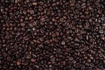 Scattered roasted coffee beans. Top view