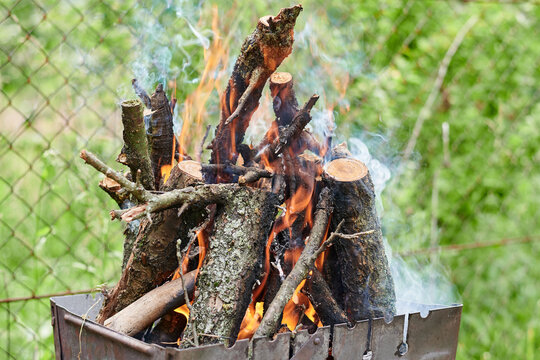 Burning wood, fire for grilling food. Risk of fire. Macro image