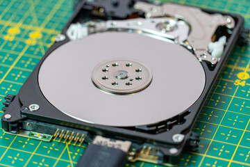 Disassembled, open hard drive in service. Repair, information recovery concept