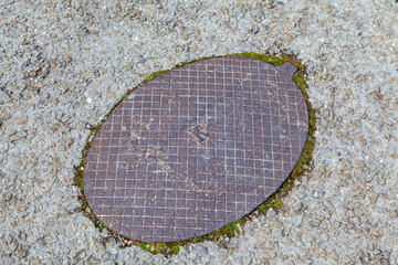 Old cast iron hatch on the road