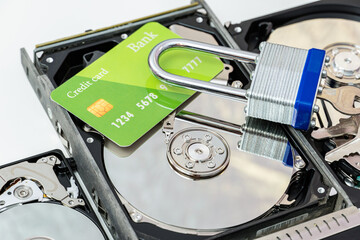 hard disk drive with credit card and lock. ransomware virus, data protection concept