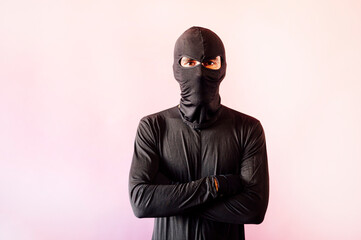 Robber man dresThief man dressed in black with masksed in black with gunThief man dressed in black...