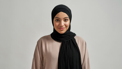 Portrait of cheerful young arabian girl in black hijab - obrazy, fototapety, plakaty