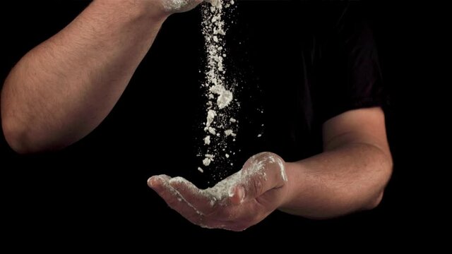 Super slow motion cooking baking with men's hands. On a black background. Filmed on a high-speed camera at 1000 fps.High quality FullHD footage