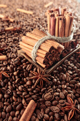 Coffee beans with anise and cinnamon sticks.