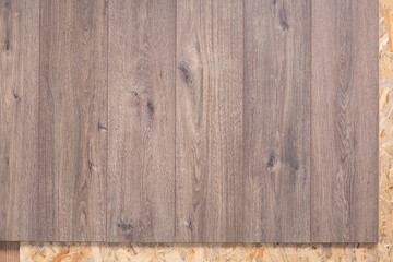 Laminate floor on wood osb background texture. Wooden laminate floor and chipboard background
