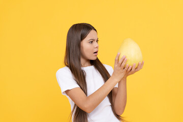 it is so big. fruit diet. amazed teenage girl with pomelo. vitamin and dieting. healthy food eating.