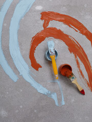 paint and paint brushes lie on the floor