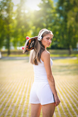 Portrait of the girl with the skateboard.  hobbies, woman style, board