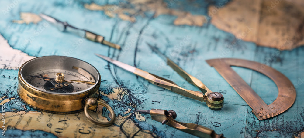 Poster an old geographic map with navigational tools: compass, divider, ruler, protractor. view of the work